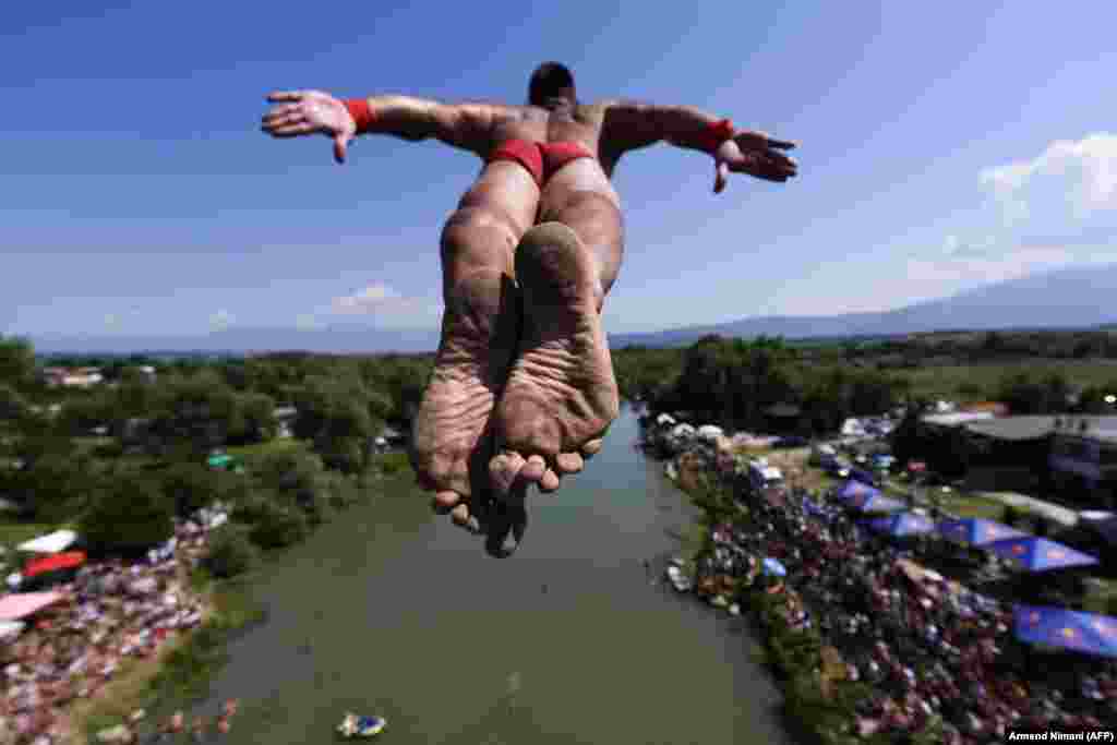 A man jumps from a bridge during the traditional annual high-diving competition near the town of Gjakova in western Kosovo. (AFP/Armend Nimani)