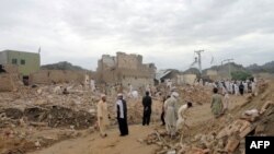 Local residents search for their belongings in the rubble of destroyed houses following a terrorist attack near a police station in the Lakki Marwat district of Khyber Pakhtunkhwa province in 2011.