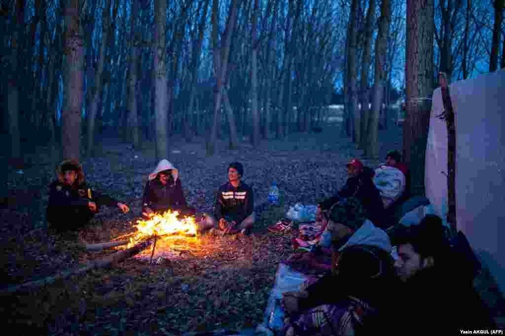 A group of migrants rest by a fire as they wait to cross the Meric river to reach Greece at the Turkish-Greek border on March 1.