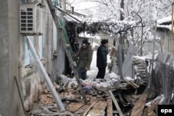 Residents of Donetsk, in Ukraine, on January 12 examine the area around their homes, which reportedly were damaged by shelling.