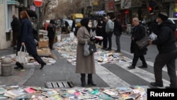 People walk on a street in Tehran on January 19, following weeks of unprecedented antigovernment protests across Iran. 