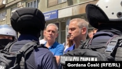 Opozicioni lideri Zdravko Ponoš (levo) i Borko Stefanović ispred kordona policije kod Pravnog fakulteta u Beogradu, 4. jul 2025.