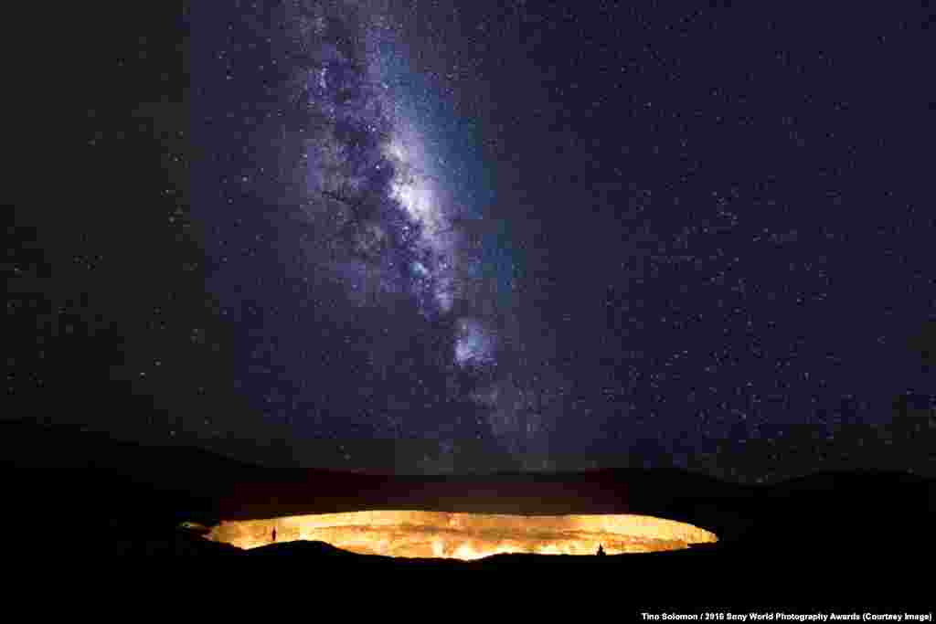Photographer Tino Solomon of the U.K.:&nbsp;The Stairway To Hell The Milky Way rises over the Darwaza crater in the Karakum desert, northwest Turkmenistan. Two explorers peer into its fiery depths, known by the local Turkmen as the Door to Hell. In 1971, Soviet scientists discovered an underground cavern with an accumulation of gas. It was set on fire to avoid a toxic release into nearby villages in the hope it would burn out within days. Yet, 45 years later, it continues to burn. Often described as the world&#39;s most beautiful ecological disaster.