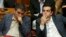 Greek Prime Minister Alexis Tsipras (right) sits next to Finance Minister Euclid Tsakalotos as he attends a parliamentary session in Athens on July 16.