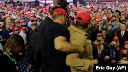 A man is restrained after he began shoving members of the media during a rally for President Donald Trump in El Paso, Texas, on February 11.
