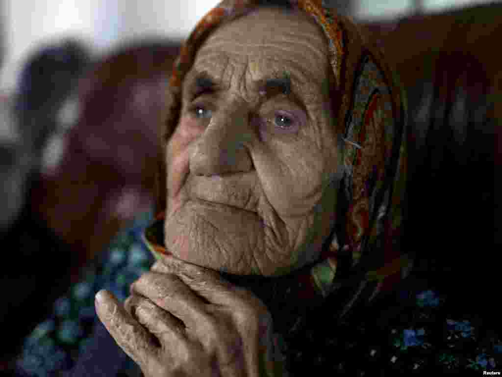 Chechen woman Kesi Karuyeva, whose official documents show she is the oldest person in the world at 116, sits inside her house in the village of Goity. (Photo by Diana Markosian for Reuters)