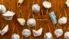 ITALY -- Protective masks bearing the names of medical staffers and nurses are pictured pinned to a wall on April 2, 2020 at the operative field hospital for coronavirus patients, financed by US evangelical Christian disaster relief NGO Samaritan’s Purse,