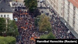 People take part in demonstrations following the killing of a German man in Chemnitz on September 1.