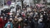 People, including pensioners, parade through the streets during a rally to protest against police violence in Minsk on November 30.