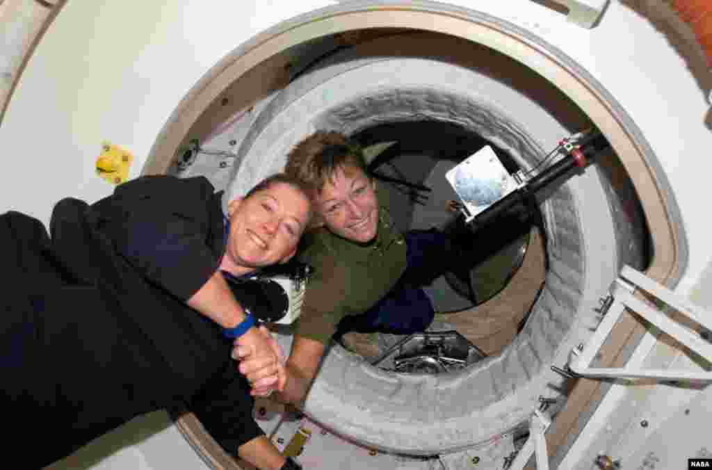 American Peggy Whitson (right), seen in a 2007 docking between the International Space Station and space shuttle &quot;Discovery,&quot; has spent more time in space (377 days) than any other woman in history.