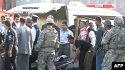 Rescue workers move a body after the suicide bombing near the Green Zone