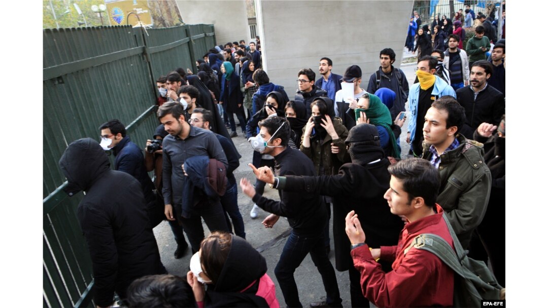 Iranian students clash with riot police during a protest around the University of Tehran on December 30.
