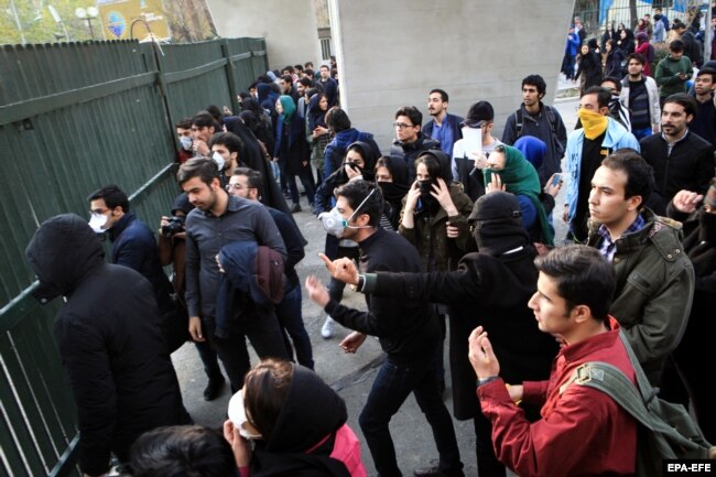 Iranian students clash with riot police during an antigovernment protest at Tehran University on December 30.