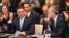 NATO Secretary-General Jens Stoltenberg (right) looks at Macedonian Foreign Minister Nikola Dimitrov as he holds a pen aloft during the signing of an "accession protocol" in a ceremony at NATO headquarters in Brussels on February 6. 