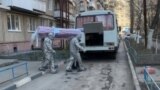 Men bringing a coffin with the body of COVID-19 infected person out of the residential building in Saratov, Russia