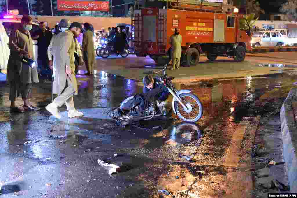 Security officials inspect the site of a bomb explosion in Quetta, Pakistan, on August 8. Two Pakistani policemen were killed and eight others injured. The separatist Baluch Liberation Army (BLA) claimed responsibility.
