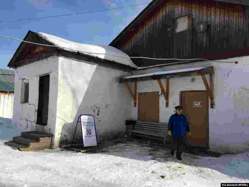 A museum worker exits a barracks block built in 1946 under Joseph Stalin.