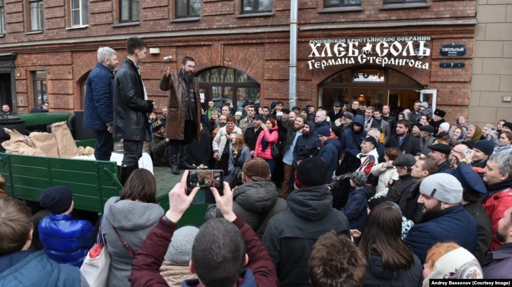 Pictured here standing on a truck in a knee-length, brown-leather jacket at the opening of one of his food stores, Russian businessman German Sterligov has sparked controversy by displaying homophobic signs on his premises.
