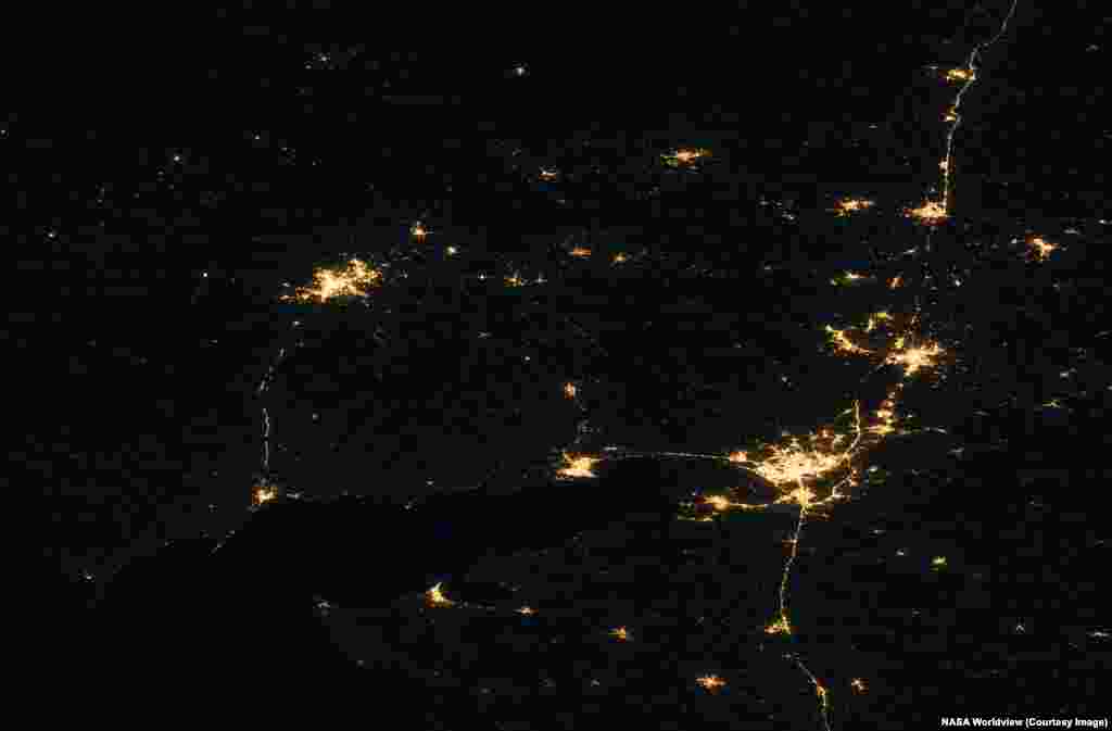 Ukraine's Donetsk Region, taking up roughly the left third of this image, and part of the Luhansk region (upper center) are seen next to Russia's Rostov region (right). The nighttime pictures were made on October 26, 2021, and July 1, 2026.Several towns in the top left of the historic image, which lie in Ukraine's Donetsk region, have fallen dark, while the bright lights of Russian-occupied Donetsk (upper left) remain largely unchanged. South of Donetsk, the now Russian-held city of Mariupol is visible at lower left of the image. Russia's Rostov-on-Don is the large city seen at lower right.