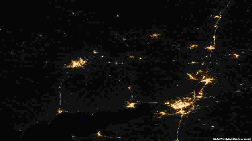Донецька область, яка займає приблизно третину зображення зліва, та частина Луганської області (у верхній центральній частині) – порівняно з Ростовською областю РФ (праворуч).Нічні знімки були зроблені 26 жовтня 2021 року та 1 липня 2026 року.Кілька міст у верхньому лівому куті архівного знімка, розташованих у Донецькій області, поринули в темряву, тоді як яскраве освітлення окупованого Росією Донецька (у верхньому лівому куті) залишилося майже незмінним.На південь від Донецька, у нижньому лівому куті зображення, видно окупований Росією Маріуполь. У нижньому правому куті розташований Ростов-на-Дону.