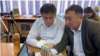 Активист Жанболат Мамай и адвокат Галым Нурпеисов сидят на онлайн-процессе. Алматы, 14 мая 2021 года.