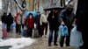 Kyiv residents stand in line to fill up bottles with fresh drinking water after critical civil infrastructure was hit by Russian missile attacks on the capital on November 24.