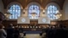 NETHERLANDS -- The delegations of the U.S., front left, and the Islamic Republic of Iran, front right, rise as judges, rear, enter the International Court of Justice, or World Court, in The Hague, October 3, 2018