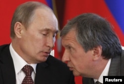 President Vladimir Putin (left) talks with Sechin during a signing ceremony at the Kremlin in Moscow in 2013.