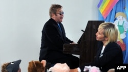 Sir Elton John plays a song for children at an orphanage in Makiyivka.