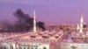 The Prophet Mohammed Mosque with smoke rising in the background in the holy city of Medina on July 4.