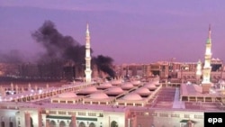 The Prophet Mohammed Mosque with smoke rising in the background in the holy city of Medina on July 4.