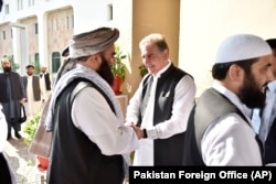 Pakistani Foreign Minister Shah Mehmood Qureshi (center) receives members of a Taliban delegation at the Foreign Office in Islamabad in October 2019.