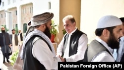 FILE: Pakistan's Foreign Minister Shah Mehmood Qureshi, center, receives members of Taliban delegation at the Foreign Office in Islamabad in October 2019.