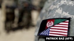 An Afghan interpreter displays a patch showing the Afghan and U.S flags. The Taliban said those who worked with foreign forces have nothing to fear if they "show remorse for their past actions." (file photo)