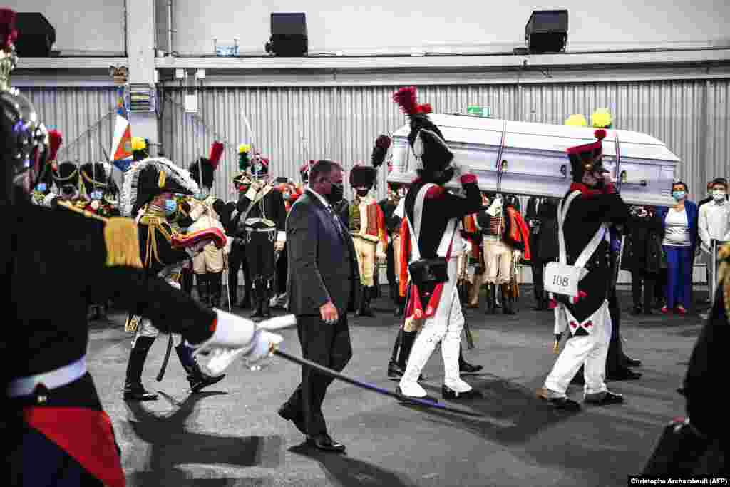 Men dressed as Napoleon-era fighters carry a coffin containing the remains of French General Charles-Etienne Gudin at Le Bourget Airport, north of Paris, on July 13. &nbsp;