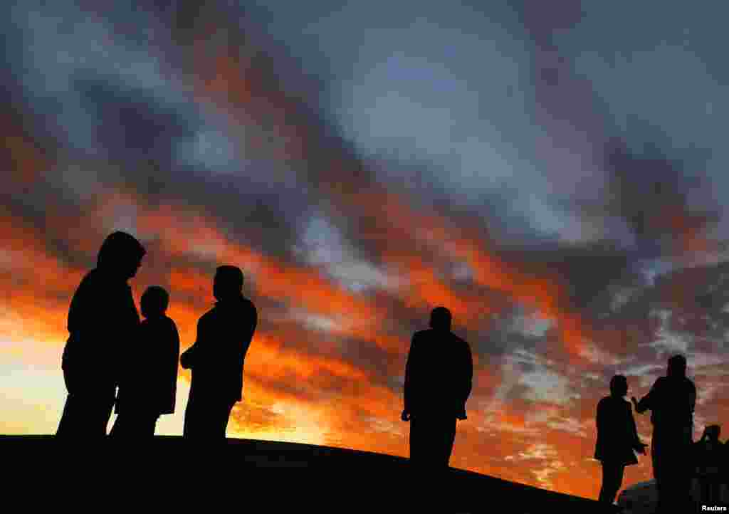 Kurdish civilians are seen atop a hill overlooking the Syrian town of Kobani in Turkey's Sanliurfa Province. People gather on the hill to watch fighting between Kurdish fighters and Islamic State militants in Kobani. (Reuters/Yannis Behrakis) 