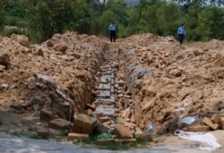 Police officers guard the site of the proposed temple in Islamabad on July 7.