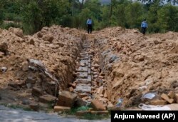 Police officers guard the site of the proposed temple in Islamabad on July 7.