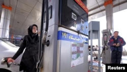 An Iranian woman fuels her car at a gas station in Tehran, January 25, 2016