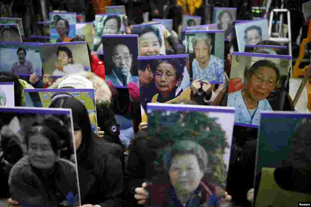 Students hold portraits of deceased former South Korean &quot;comfort women,&quot; who were forced into sexual slavery by the Japanese Army in World War II, during a weekly anti-Japan rally in front of Tokyo&#39;s embassy in Seoul on December 30. (Reuters/Kim Hong-Ji)