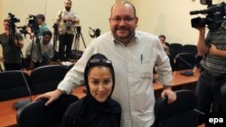 Iranian-American Washington Post correspondent Jason Rezaian (top) and his Iranian wife, Yeganeh Salehi, pose while covering a press conference at Iran's Foreign Ministry in Tehran in September 2013.