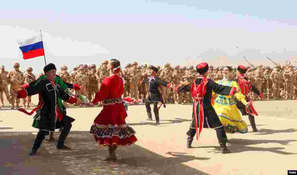 A traditional dance group performs for the troops.&nbsp;