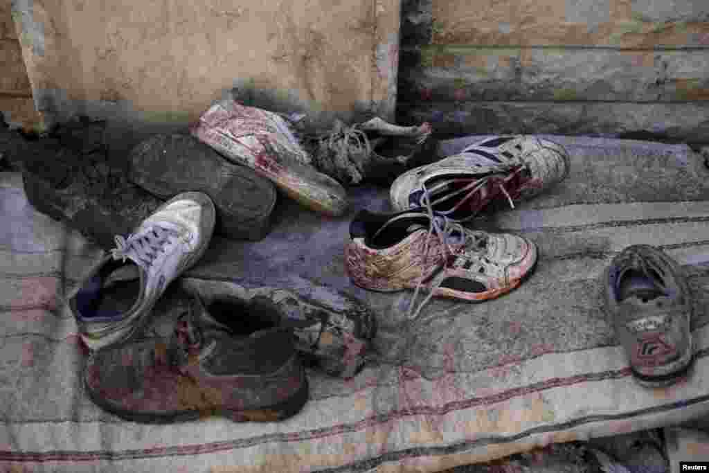 Bloodstained shoes after Syrian government forces fired missiles at a busy marketplace in Douma on October 30