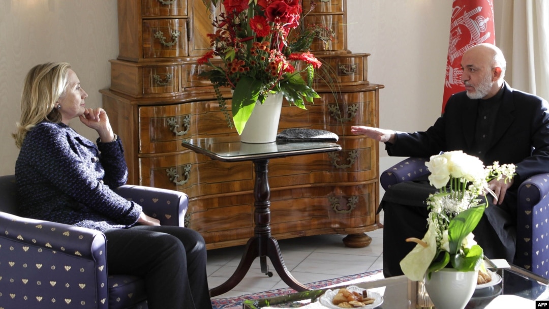 U.S. Secretary of State Hillary Clinton (left) and Afghan President Hamid Karzai speak during a bilateral meeting in Bonn.