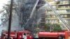 The blaze quickly engulfed a nearby building, completely destroying some 20 apartments.