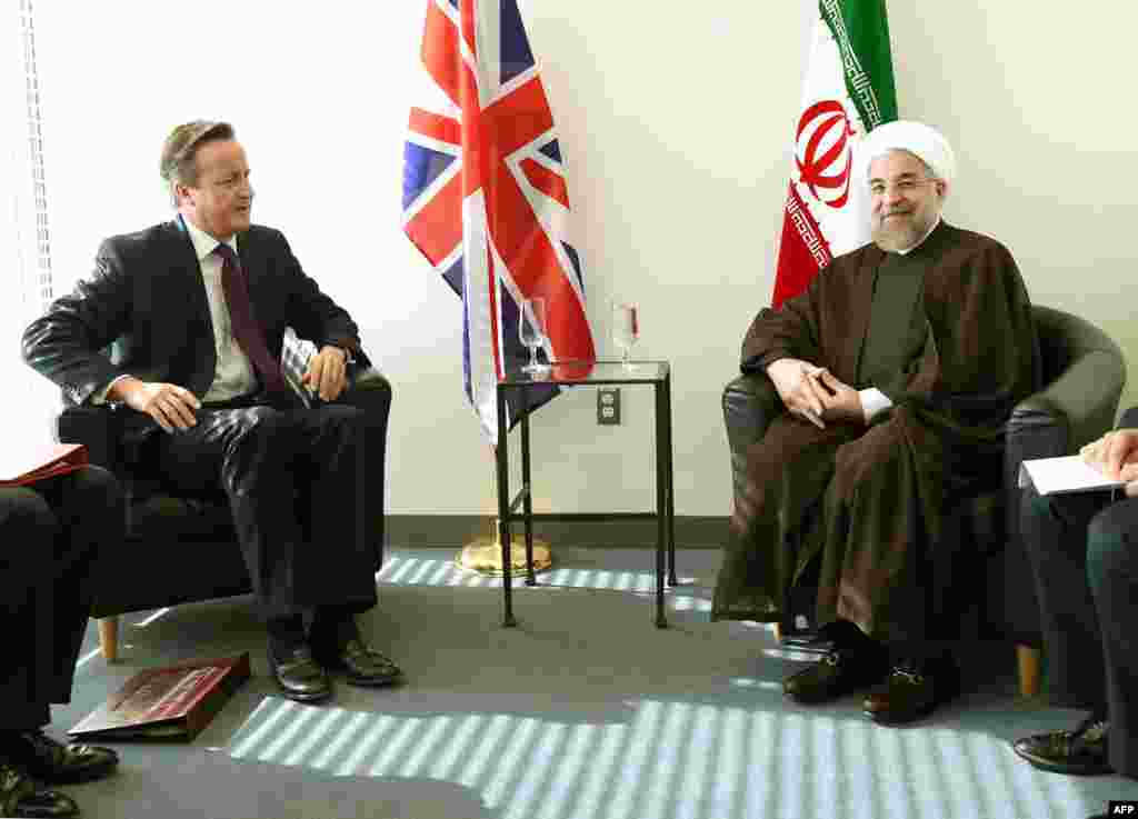 British Prime Minister David Cameron (left) meets with Iranian President Hassan Rohani at the UN during the 69th session of the UN General Assembly in New York. It was the first meeting of leaders from the two nations since Iran&#39;s Islamic Revolution in 1979. (AFP/Timothy A. Clary)