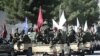 Бойцы движения "Талибан" отмечают пятую годовщину прихода к власти у здания бывшего посольства США в Кабуле, 15 августа 2026 года