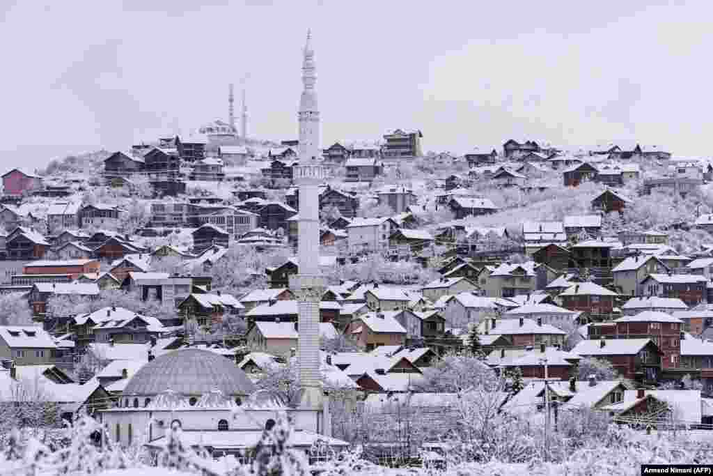 Houses are covered with snow after heavy snowfalls on the outskirts of Pristina, Kosovo, on February 5. (AFP/Armend Nimani)&nbsp;