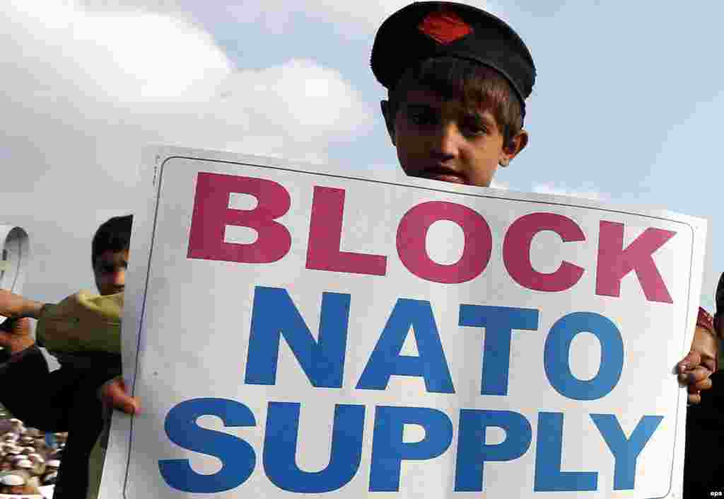 A young supporter of the Islamic political party Jamat-e Islami holds a placard during a protest against a U.S. drone attack in &nbsp;the North Waziristran tribal agency, in Peshawar, Pakistan. (epa/Arshad Erbab)