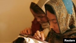 Afghan women sew clothes at a design shop in Kabul. (file photo)